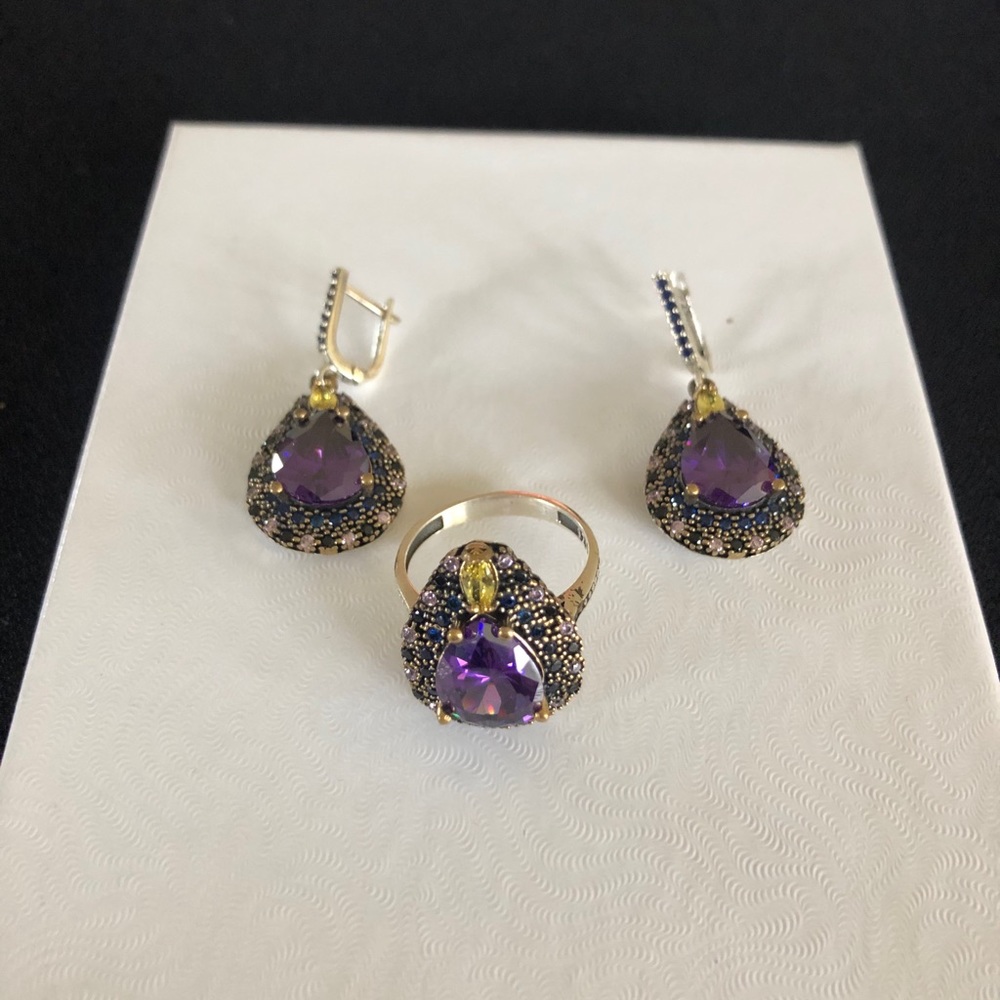 Silver ring with matching earring. Purple center